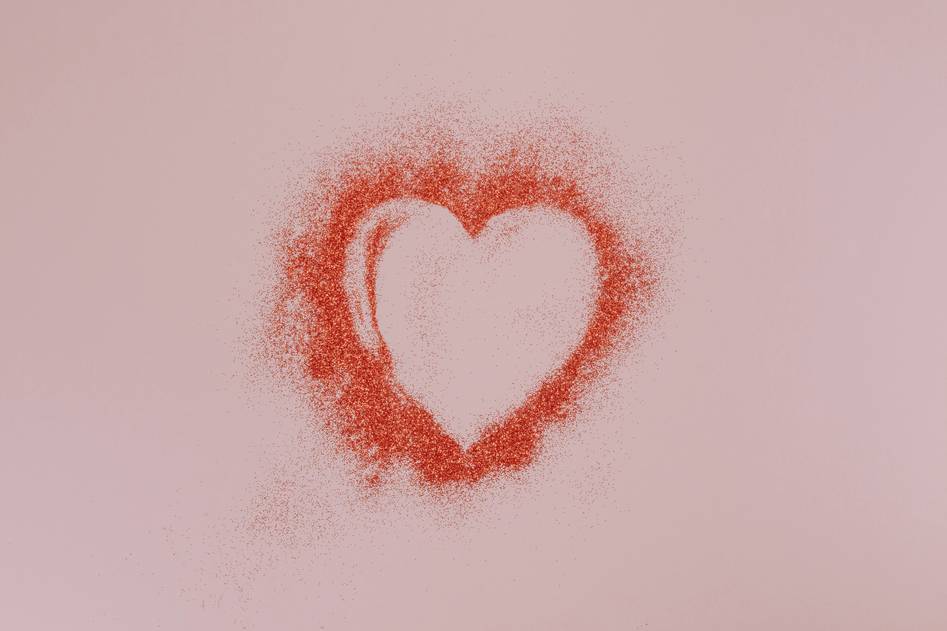 Blogger arranging pink and red Valentine's accents on a wooden table