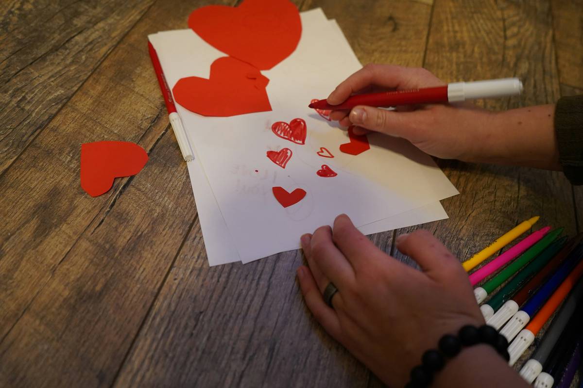 valentine s day decor ideas diy featuring linen banners, dried roses, and wooden accents on a neutral-toned console table